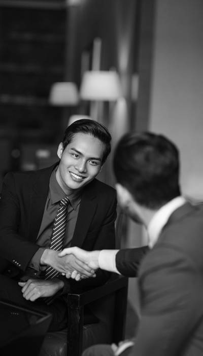 two-smiling-partners-shaking-hands-cafe